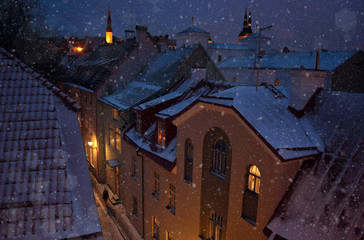 Fototapeta na wymiar dormer and roofs of a medieval city in winter