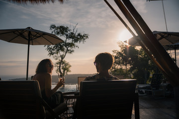 A couple enjoying drinks at sunset in Bali