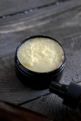 Brown cosmetic bottles on wooden table flat lay