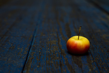 Apple, natural non-GMO, without chemistry, with a child's hand, on a wooden old background