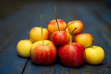 Apple, natural non-GMO, without chemistry, with a child's hand, on a wooden old background
