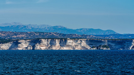Limestone cliffs near Bonifacio, Corsica, France, viewed out of the ferry approaching a harbor.