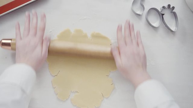 Step by step. Flat lay. Rolling out Sugar cookie dough with French rolling pin.