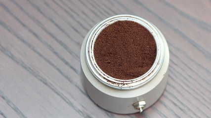 Natural coffee powder in aluminum cans on wooden table, top view.