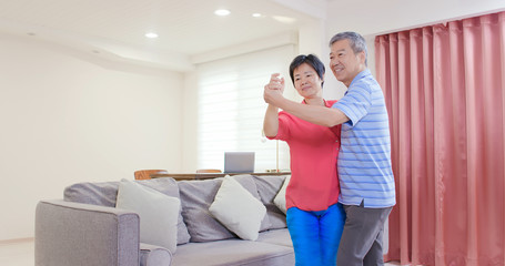 asian eldely couple dance together