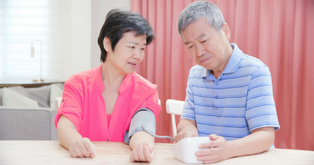 elder couple use blood manometer