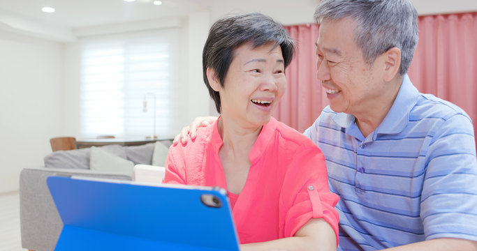 elderly couple use digital tablet