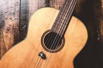 classical guitar on wood planks
