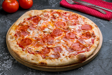 Italian meat pizza on grey concrete table