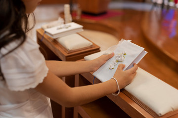 First communion ceremony in church - little girl in white dress