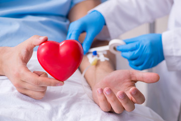 Male patient getting blood transfusion in hospital clinic