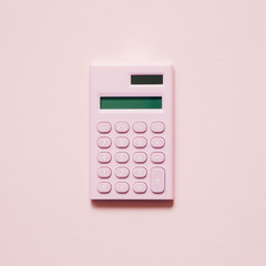 Pink digital calculator on pink background