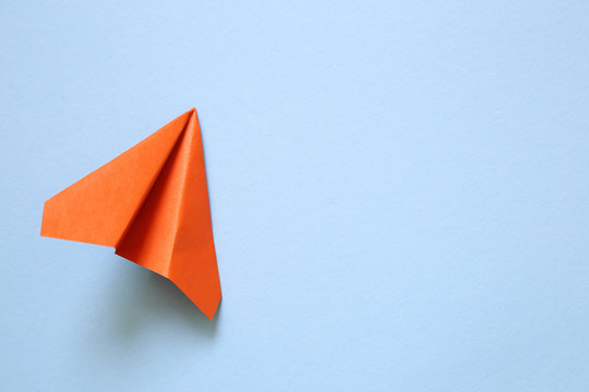 Orange Paper Plane On Blue Background