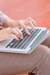 Fototapeta na wymiar Woman typing on keyboard of computer laptop