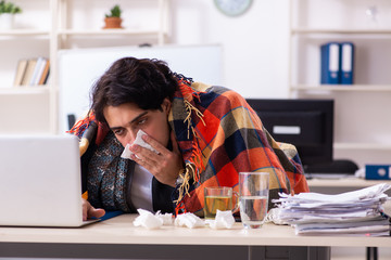 Man with flu working in the office