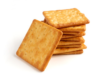 Crushed dry cracker cookies isolated on white background. Selective focus.