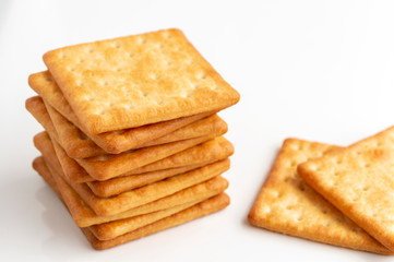 Crushed dry cracker cookies isolated on white background. Selective focus.