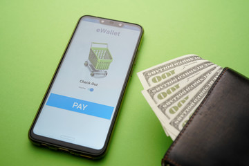 A mobile app eWallet conceptual with mock up apps and dollar bill inside wallet