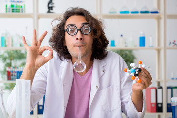 Funny male chemist working in the lab