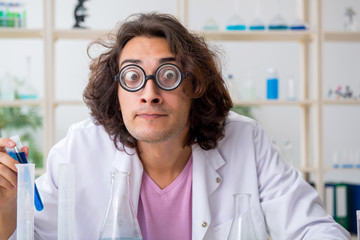 Funny male chemist working in the lab