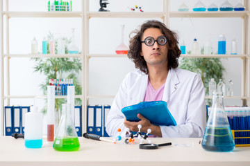 Funny male chemist working in the lab