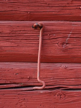 red wooden backgroundwith netal hook