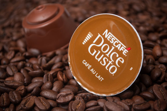 Mulhouse - France - 21 September 2019 - Closeup of a Dolce gusto nescafe expresso coffee capsules on coffee beans background