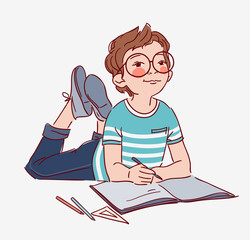 Little, cute boy writing in notebook