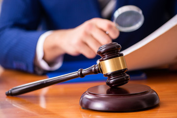 Young male judge sitting in courtroom