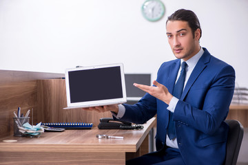 Young handsome businessman working in the office