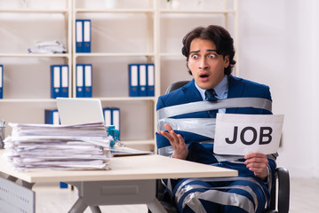 Young tied male employee in the office