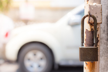 The padlock on the old iron fence gate