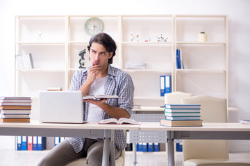 Young male student preparing for exams at home