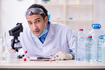 Young male chemist experimenting in lab