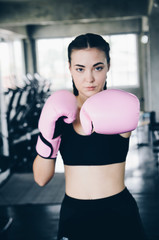 Fototapeta na wymiar Attractive Female Boxer At Training in gym