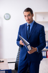 Young male accountant working in the office