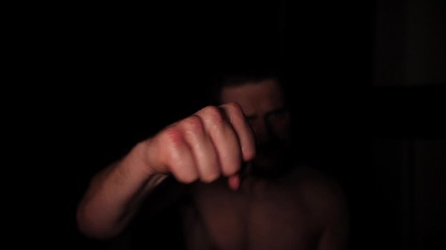 Slow motion - Boxer fighter punching the camera, sweating and training boxing