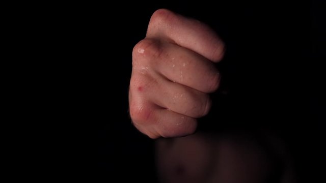 Slow motion - Boxer fighter punching the camera, sweating and training boxing