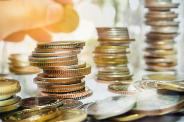 Graphs and rows of coins to communicate finance, investment, money collection and money management that have grown and have business value.