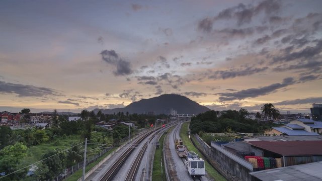 Timelapse colorful red sunrise of over the railway road at station KTM Bukit Mertajam,