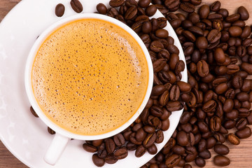 Cup Of Coffee With Roasted Coffee Beans Isolated On White