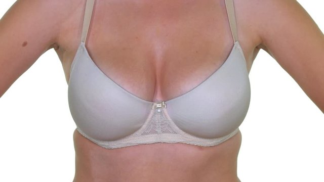 Model Woman with big breasts and white bra against a white background.