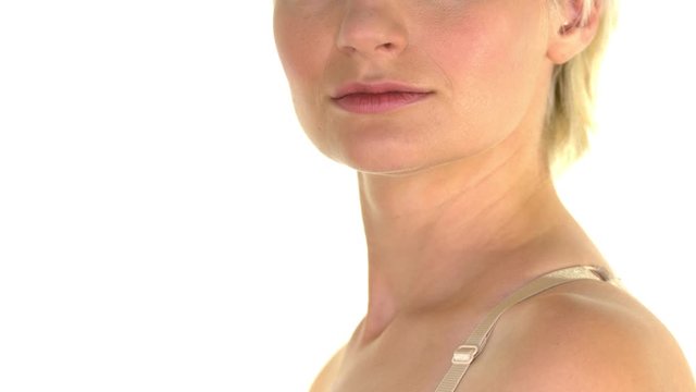 Close-up of a beautiful woman with short blond hair. Pan shot at the end.