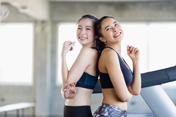 Group attractive asian woman stretching the muscles and relaxing after exercise, workout, fitness at gym club. Sports recreation glad smiling girl is enjoy with her training process.