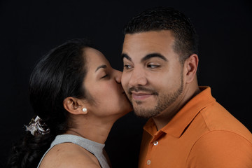 Woman kissing man. Happy couple.  loving couple, only you and me. Black background