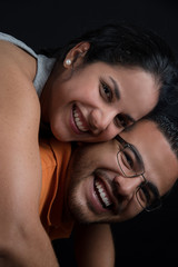Happy and smiling couple in a warm embrace. Happy couple. loving couple, only you and me. Black background