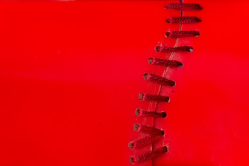 Texture stitching shoe lace in red plastic background