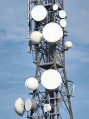 Group of antennas, satellite dishes for telecommunications, television broadcast, cellphone, radio and satellite on Linzone mountain peak. Electromagnetic and environmental pollution. Italian Alps