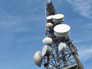 Group of antennas, satellite dishes for telecommunications, television broadcast, cellphone, radio and satellite on Linzone mountain peak. Electromagnetic and environmental pollution. Italian Alps