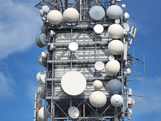 Group of antennas, satellite dishes for telecommunications, television broadcast, cellphone, radio and satellite on Linzone mountain peak. Electromagnetic and environmental pollution. Italian Alps